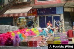 Customers flock to markets selling gifts and sweets for the Hindu festival of Diwali.