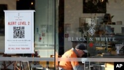 A man enjoys coffee in a cafe in Christchurch, New Zealand, May 14, 2020. 
