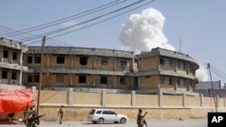 Soldiers stand on alert near an explosion near the presidential palace in the capital Mogadishu, Somalia, Dec. 22, 2018. 