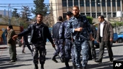FILE - Hamas policemen break up a rally calling for Palestinian political reconciliation in Gaza City. The New York-based Human Rights Watch said in a report April 6, 2011, that the Palestinian Authority has stepped up harassment of journalists investigating corruption or believed to support the rival Hamas militant group.