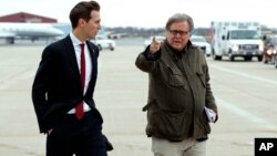 FILE - Jared Kushner, son in-law of President-elect Donald Trump, left, walks with Trump's Chief Strategist Stephen Bannon at Indianapolis International Airport, Dec. 1, 2016.