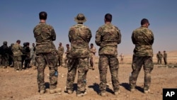 FILE - U.S. special operations forces watch a multinational military exercise in Zarqa, Jordan, in 2013. Al-Rai newspaper said a Jordanian officer opened fire on American and South African trainers Nov. 9, 2015. 