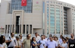 Journalist are seen gathered outside a court building to support a colleague who was detained in connection with the investigation launched into the recent failed coup attempt in Turkey, in Istanbul, July 27, 2016.