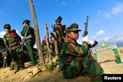 FILE - A TNLA (Ta'ang National Liberation Army) soldier looks on, during the 51st anniversary of the Ta'ang National Resistance Day at Homain, Nansan township in the northern Shan state, Jan. 12, 2014.
