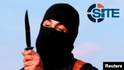 FILE - A masked, black-clad militant, believed to he "Jihadi John" of the Islamic State group dubbed "The Beatles," brandishes a knife in this still image from a 2014 video obtained from SITE Intel Group Feb. 26, 2015. 