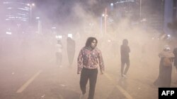 People clash with anti-riot police outside the Israeli consulate during a protest to show solidarity with Palestinians, in Istanbul early on Oct.18, 2023.