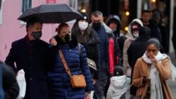 Shoppers in the crowd wear face masks against the ongoing pandemic on Oxford Street in London, Dec. 24, 2021.