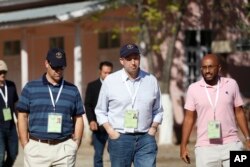 U.S. Ambassador to Myanmar Derek Mitchell, center, an observer of Myanmar elections, walks from a polling station in Mandalay, Myanmar, Nov. 8, 2015.