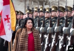 Georgia's President Salome Zourabichvili reviews the honor guard during a welcome ceremony at the Presidential palace in Vilnius, Lithuania, March 7, 2019.