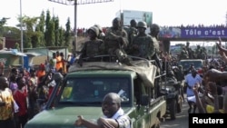 Residents cheer at army soldiers as they celebrate the uprising in Conakry, Guinea, Sept. 5, 2021. 