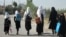 FILE - Afghan girls walk to their school in Gardez on Sept. 8, 2022. A Taliban official said on March 12, 2024, that the Taliban may permanently close girls' secondary schools, which already had been shut down in 2022.