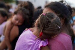 Migrants, many who were returned to Mexico under the Trump administration’s “Remain in Mexico” program, wait in line to get a meal in an encampment near the Gateway International Bridge in Matamoros, Mexico, Aug. 30, 2019.