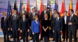 FILE - German Chancellor Angela Merkel, front 3rd left, and French president Emmanuel Macron, front 2nd left, pose during for a group photo at a meeting with Balkan leaders at the chancellery in Berlin, Apr. 29, 2019. (Michael Sohn/Pool via Reuters)