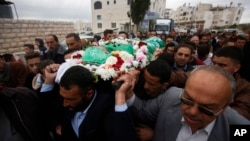 FILE - Palestinians chant slogans as they carry the body of Abdel-Fattah al-Sharif, during his funeral, in the West Bank city of Hebron, May 28, 2016. On Wednesday, an Israeli military court convicted a young soldier, Sgt. Elor Azaria, of manslaughter in the killing of al-Sharif.