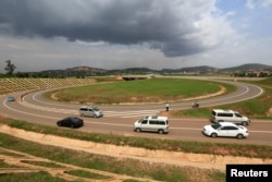 FILE - Vehicles drive on the interchange of the new Chinese-built 51-kilometer (31-mile) four-lane expressway connecting Uganda's capital Kampala to Entebbe International Airport, in Kampala, Uganda, Jan. 29, 2018.