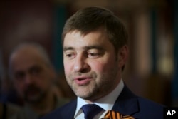 FILE - Sergei Zheleznyak, deputy speaker of the Russian parliament's lower house, speaks to reporters in Moscow, March 18, 2014.