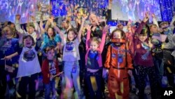 A man hugs Pope Francis to take a selfie after he had climbed on the popemobile at the end of the weekly general audience in St. Peter's Square at the Vatican.