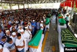 FILE - Family members and friends of victims of a suicide bombing at a wedding celebration attend their funeral ceremony in the southern Turkish city of Gaziantep, Turkey, Aug. 21, 2016.