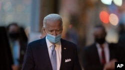 President-elect Joe Biden walks to speak to the media as he leaves The Queen theater, Nov. 24, 2020, in Wilmington, Del.