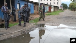 FILE - Burundian police and soldiers guard a deserted street in Bujumbura, Burundi.