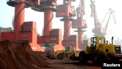 FILE - Workers transport soil containing rare earth elements for export at a port in Lianyungang, Jiangsu province, China, Oct. 31, 2010. 