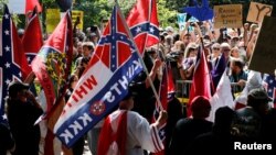 Members of the Ku Klux Klan face counter-protesters as they rally in support of Confederate monuments in Charlottesville, Virginia, July 8, 2017. 