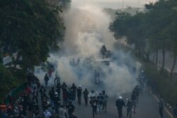 Police use a water cannon and tear gas to disperse protesters taking part in a demonstration calling for the resignation of Thailand's Prime Minister Prayut Chan-ocha.