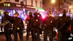 FILE - Riot police clear an intersection in Washington, Jan. 20, 2017, after the inauguration of President Donald Trump.