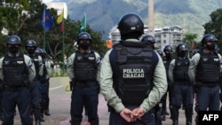 FILE - Municipal police officers prepare for a security operation, in Caracas, Venezuela, Dec. 1, 2020.