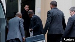 FILE - Men unload a case containing the black boxes from the crashed Ethiopian Airlines Boeing 737 MAX 8 outside the headquarters of France's BEA air accident investigation agency in Le Bourget, north of Paris, France, March 14, 2019. 