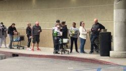 Lines outside grocery stores are not uncommon. Items such as toilet paper and sanitizers are in high demand and hard to find. (Elizabeth Lee/VOA)