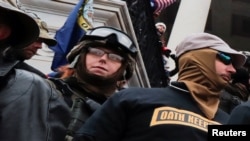 FILE - Members of the Oath Keepers militia group stand among supporters of former President Donald Trump protesting the certification of the 2020 presidential election results on the east front steps of the Capitol, Jan. 6, 2021.