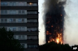 Smoke and flames rise from a building on fire in London, June 14, 2017.