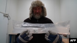 Joergen Peder Steffensen, professor of ice core-related research at the Niels Bohr Institute, University of Copenhagen, holds part of an ice core sample in the University of Copenhagen’s ice core repository in Copenhagen, Denmark, on Oct. 26, 2023.