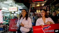 Pauline Ngarmpring, left, a transgender person and a prime minister candidate, and Namklenginarin, right, also a candidate, both representing Mahachon Party for upcoming Thai general election, campaign in Bangkok, Feb. 13, 2019.