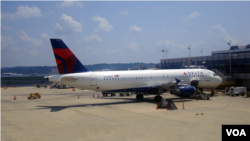 FILE - A Delta Airlines plane parks at the Ronald Reagan-Washington National airport, just outside Washington, DC. Airlines, airports and air traffic management companies are sharing more information than ever before to make flying more efficient. (Photo: Diaa Bekheet)