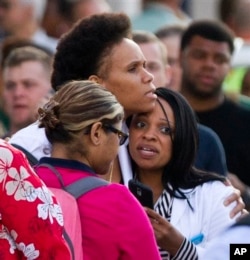 Family and friends wait to greet Navy staff as they are bused to Nationals Park, in Washington, Sept. 16, 2013.