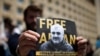 FILE - A man attends a rally to support an Azerbaijani journalist Afgan Mukhtarli, who was abducted in Tbilisi on May 29, then held in detention in Baku, in Tbilisi, Georgia, May 31, 2017.
