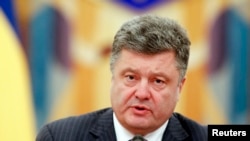 FILE - Ukrainian President Petro Poroshenko takes part in a meeting of the security council in Kyiv, June 16, 2014.