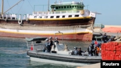 Chinese navy officers dock on the shores of the Gulf of Aden.