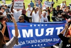 FILE - Protesters clash with Trump supporters in West Palm Beach, Fla., Sept. 22, 2018.