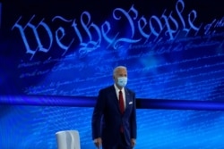 FILE - Democratic presidential candidate Joe Biden arrives to participate in a town hall with moderator ABC News anchor George Stephanopoulos at the National Constitution Center in Philadelphia, Oct. 15, 2020.