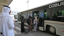 Passengers enter in a shuttle bus before boarding a Qatar Airways aircraft at the airport in Kabul. September 9, 2021.