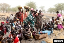 FILE - Women and children wait to be treated at a support clinic in Thaker, South Sudan, March 20, 2017. More than 3 million South Sudanese have been uprooted by civil war since December 2013, with famine adding to their hardships.