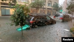 Vehicles sit in high waters after heavy rain in New Orleans, Louisiana, July 10, 2019, in this image obtained from social media.