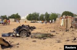 FILE - Damage is seen following an attack by Boko Haram militants in the northeast city of Maiduguri, Nigeria, April 27, 2018.