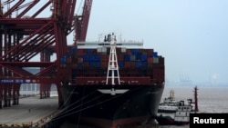 FILE - A cargo ship is anchored at a port in Zhoushan, Zhejiang province, Feb. 14, 2016. China's exports fell 11.2 percent in January from a year earlier and imports tumbled 18.8 percent.