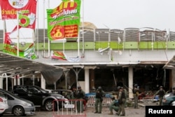 Military personnel inspect the site of a bomb attack at a supermarket in Pattani, Thailand, May 10, 2017.