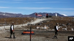 FILE - Indian army soldiers walk along the line of control at the India- China border in Bumla in the northeastern Indian state of Arunachal Pradesh, Oct. 21, 2012. 