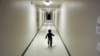 FILE - An asylum-seeking boy from Central America runs down a hallway after arriving from an immigration detention center to a shelter in San Diego, Dec. 11, 2018.
